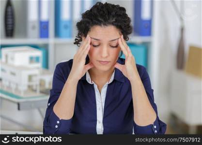 portrait of businesswoman with headache