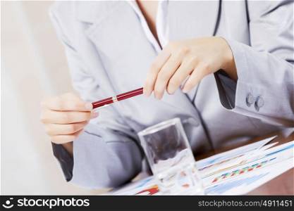 Portrait of businesswoman with laptop working at her office