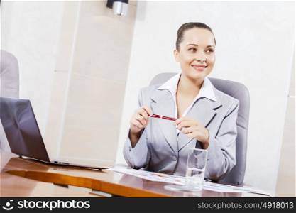 Portrait of businesswoman with laptop working at her office. Beautiful office manager