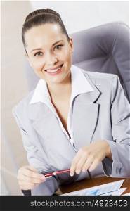 Portrait of businesswoman with laptop working at her office. Beautiful office manager
