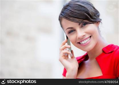 Portrait of businesswoman with mobile phone. Portrait of beautiful business woman in red dress holding her mobile