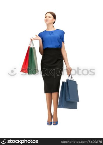 portrait of businesswoman with shopping bags on high heels