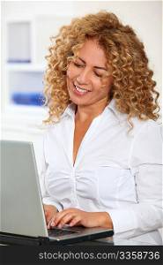 Portrait of businesswoman working on laptop