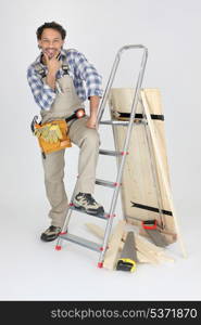 portrait of cabinetmaker posing near ladder