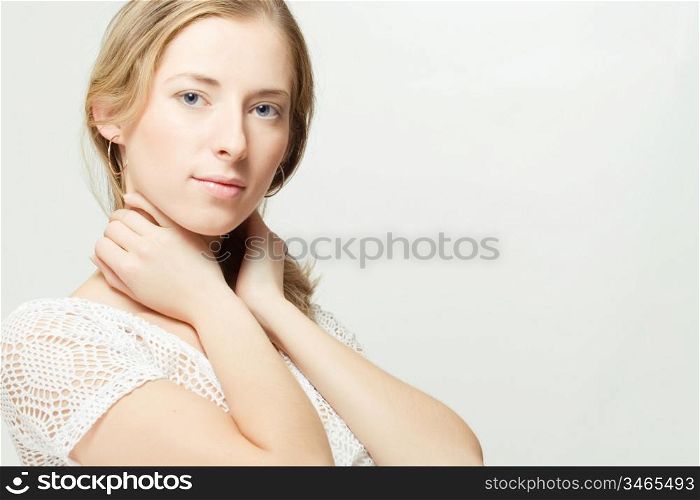 portrait of calm young woman, over gray background, with copyspace