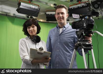Portrait Of Cameraman And Floor Manager In Television Studio