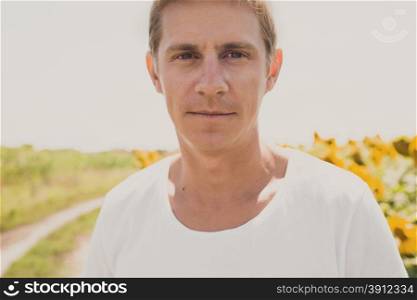 Portrait of casual man in white shirt, summertime outdoor