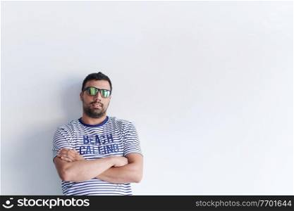 portrait of casual startup businessman with crossed arms wearing a T-shirt and sunglasses isolated on white background
