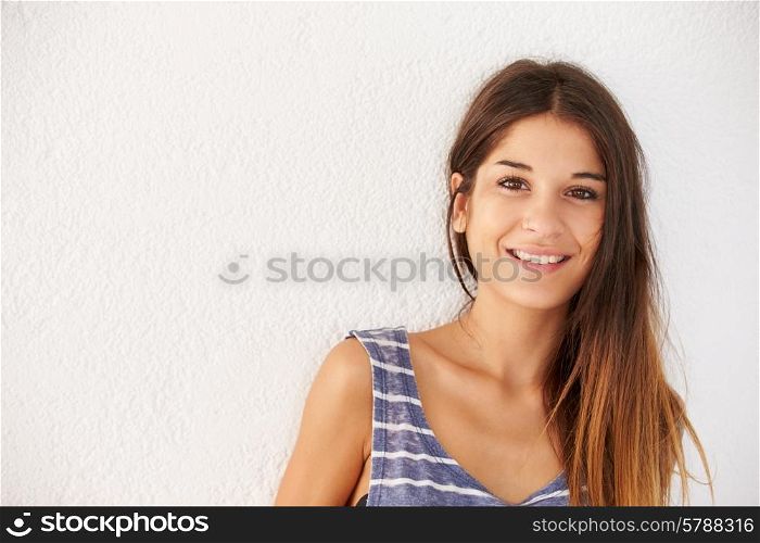 Portrait Of Casually Dressed Woman Leaning Against Wall