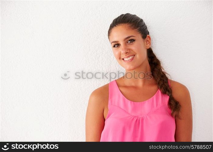 Portrait Of Casually Dressed Woman Leaning Against Wall