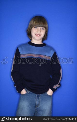 Portrait of Caucasian boy with hands in pockets.