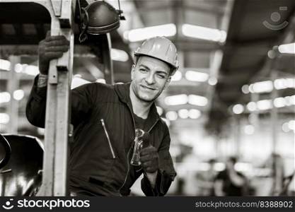 Portrait of Caucasian factory worker handsome smart with safety clothes. Industrial art black and white photography.