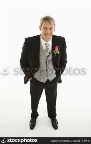 Portrait of Caucasian groom with hands in pockets.
