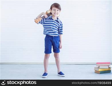 Portrait of caucasian little boy is playing guitar on white background with copy space