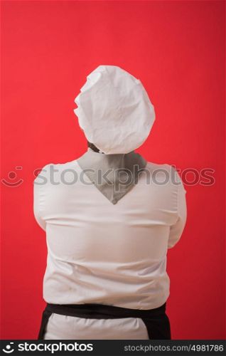 Portrait of caucasian man with chef uniform thinking. View from behind