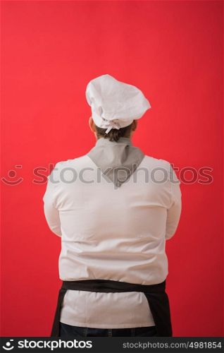Portrait of caucasian man with chef uniform thinking. View from behind