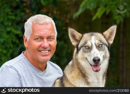 Portrait of caucasian man with husky dog