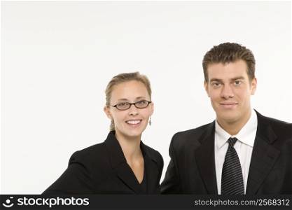 Portrait of Caucasian mid-adult businessman and woman smiling and looking at viewer.