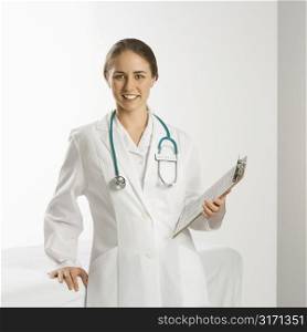 Portrait of Caucasian mid-adult female doctor smiling and looking at viewer.
