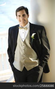 Portrait of Caucasian mid-adult groom in tuxedo smiling.