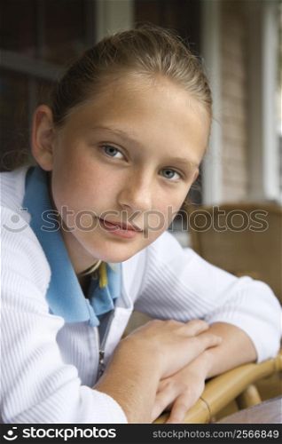 Portrait of Caucasian pre-teen girl looking at viewer.