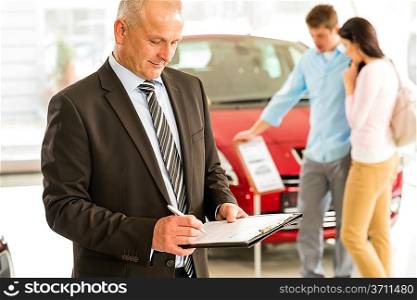Portrait of Caucasian salesman in car showroom