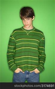 Portrait of Caucasian teen boy with hands in pockets.