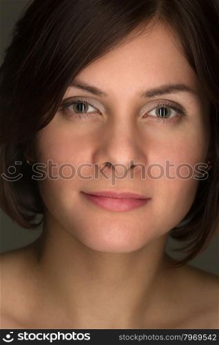 Portrait of charming girl close-up on a dark background.