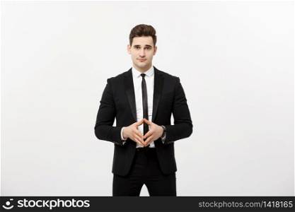 Portrait of cheerful, attractive, handsome businessman holding hands with confident face looking at camera standing over grey background.. Portrait of cheerful, attractive, handsome businessman holding hands with confident face looking at camera standing over grey background