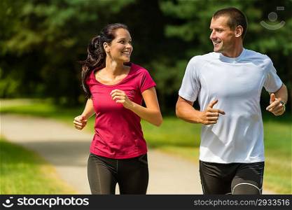 Portrait of cheerful Caucasian couple running outdoors