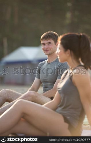 Portrait of cheerful couple resting after running outdoors