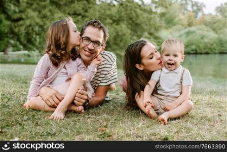 Portrait of cheerful family resting in the summer park