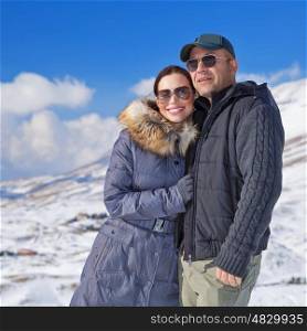 Portrait of cheerful family spending winter holidays in the mountains, romantic relationship, travel on Valentine day, wintertime vacation concept