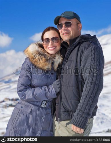 Portrait of cheerful family spending winter holidays in the mountains, romantic relationship, travel on Valentine day, wintertime vacation concept