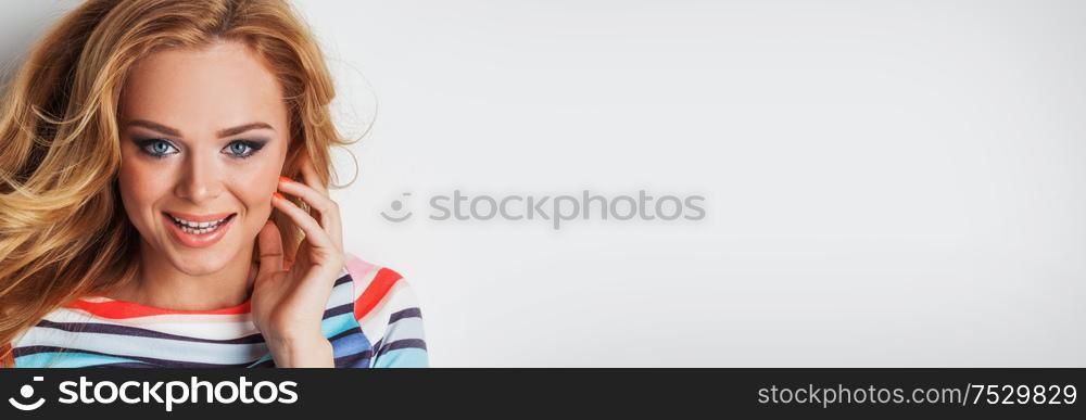 Portrait of cheerful, funny, successful, confident, laughing with open mouth, smiling girl in striped outfit looking at camera isolated grey background. Portrait of cheerful smiling girl