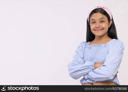 Portrait of cheerful girl looking at camera against plain background