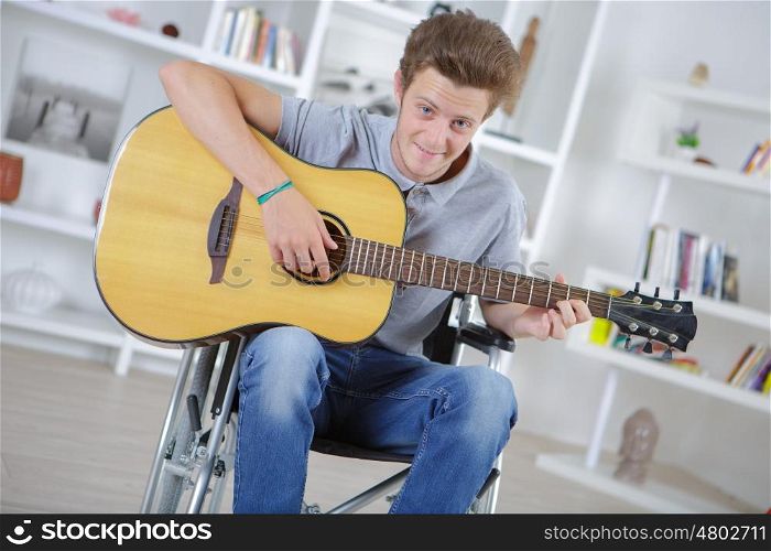 portrait of cheerful handicapped man with guitar