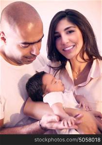 Portrait of cheerful mother and father holding on hands cute sleeping newborn baby, spending time at home, happy young family, love and happiness concept
