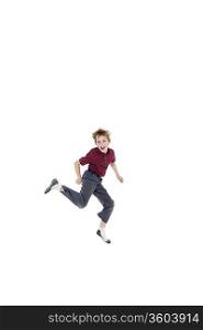 Portrait of cheerful pre-teen boy jumping over white background