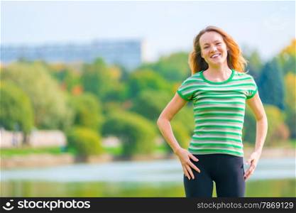 portrait of cheerful red-haired girl in a green T-shirt