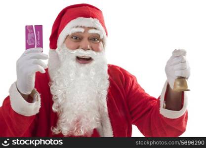 Portrait of cheerful Santa Claus showing gift voucher card with bell in other hand