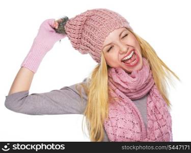 Portrait of cheerful teenager girl in winter hat and scarf