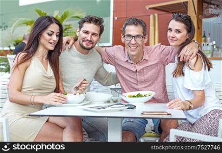 Portrait of cheerful, young freinds in the summer restaurant