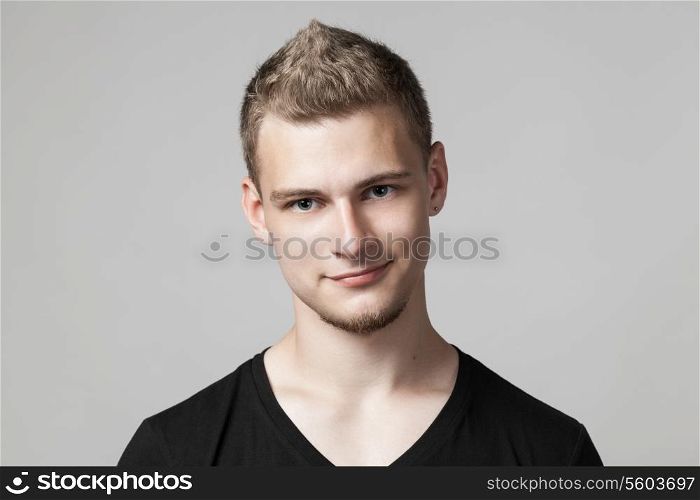 portrait of cheerful young man isolated on light background