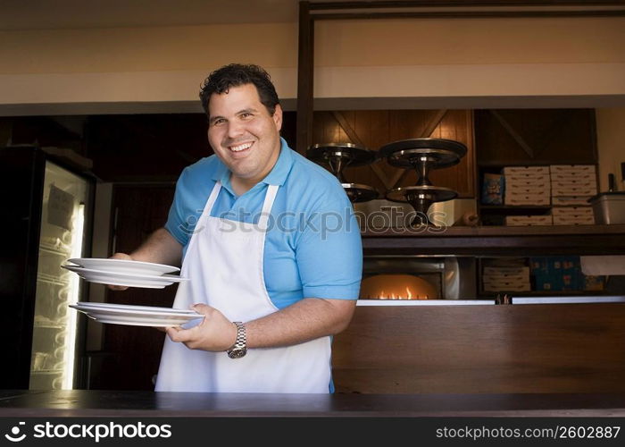 Portrait of chef behind restaurant counter