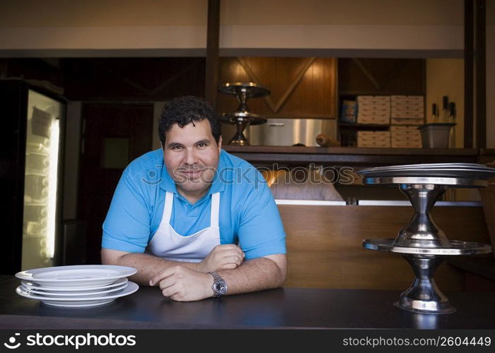 Portrait of chef behind restaurant counter