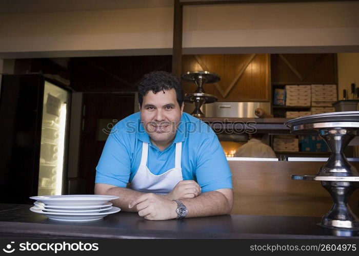 Portrait of chef behind restaurant counter