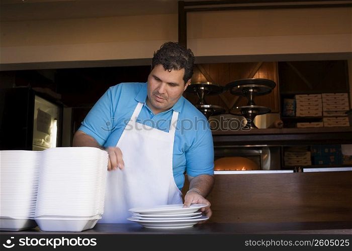 Portrait of chef behind restaurant counter