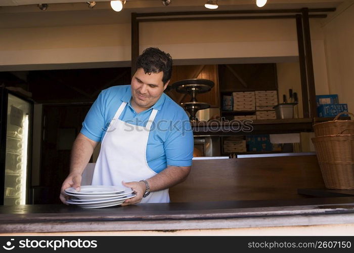 Portrait of chef behind restaurant counter