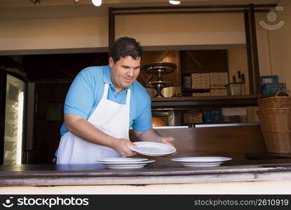 Portrait of chef behind restaurant counter